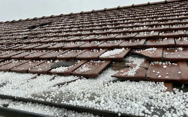 Hail stones on a damaged tile roof